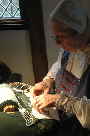 Linda Lane working with bobbins; Bobbin lacemaker; 2015: Salem, Massachusetts