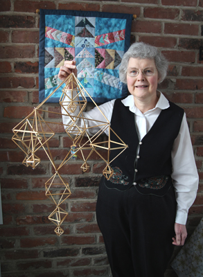 Susan Urban holding a pajak made of straw; Polish straw craft; 2013: West Springfield; Straw